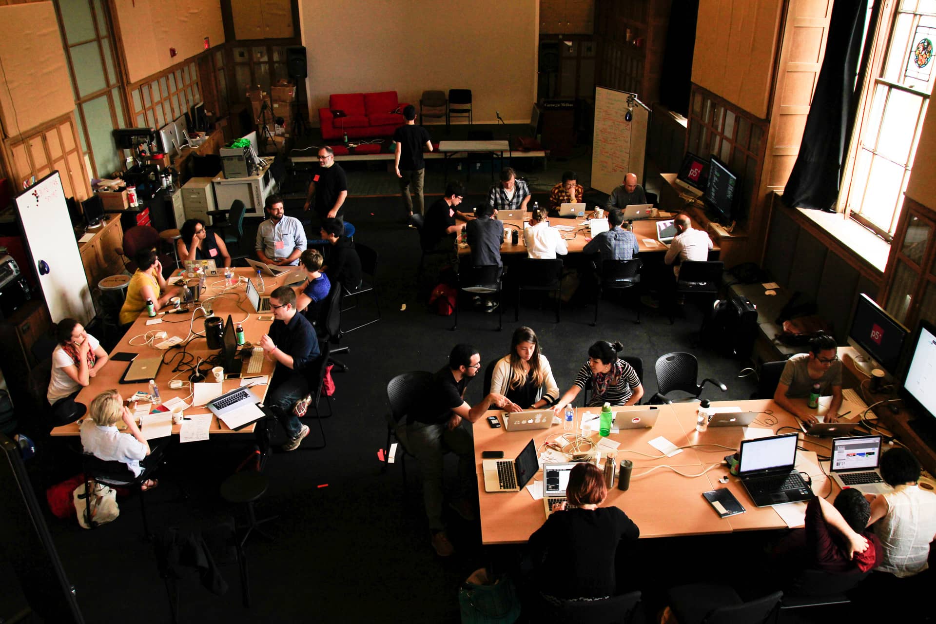 Overhead view of a classroom with participants working on their laptops"