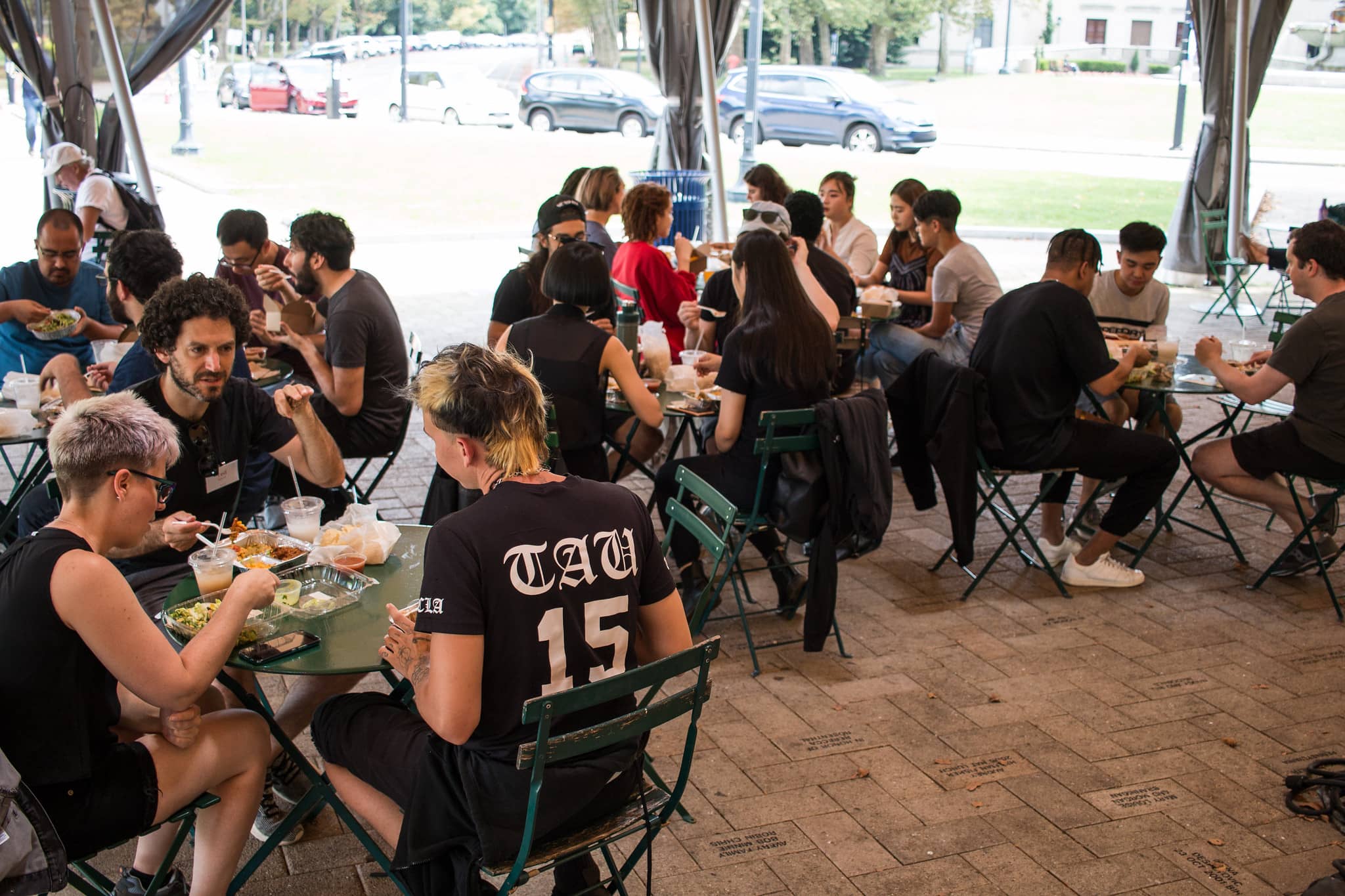 Participants sitting outside eating lunch together"